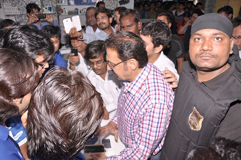 An Omax protection officer holding back a crowd around a public figure